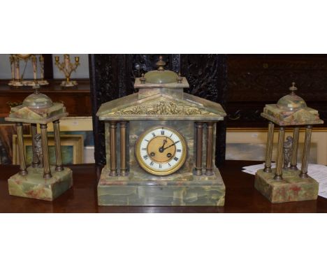 A green onyx striking mantel clock with garniture, retailed by W Lockwood, 3 Victorian Lane, Huddersfield 