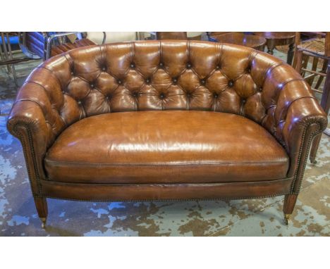 SOFA, Georgian design, with curved back and arms and deep button upholstered and brass studded in hand finished leaf brown le