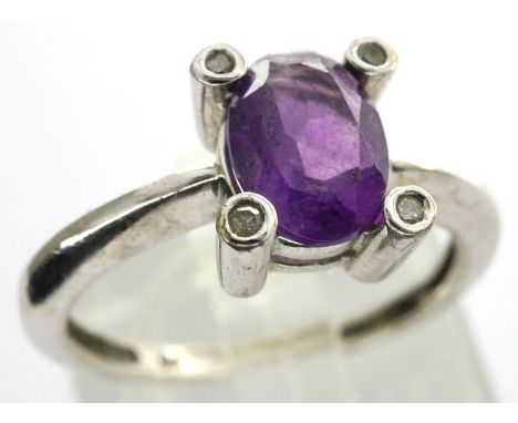 9ct white gold dress ring set with an amethyst and four diamonds, size I/J, 1.6g. P&amp;P Group 1 (£14+VAT for the first lot 