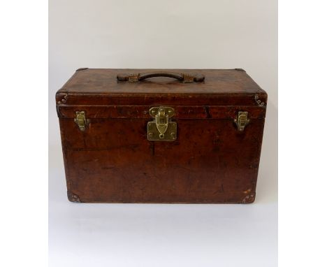 Louis Vuitton, an early 20th Century Louis Vuitton steamer trunk, tan leather with studded corner guards, brass fittings, R.L