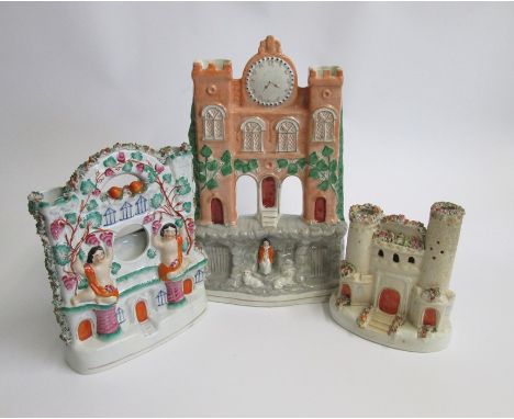 Three Victorian Staffordshire Groups, one as a clock tower one as a watch holder and one as a castleDate: mid 19th centurySiz