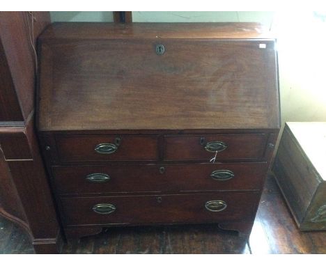 A George III mahogany bureau, fall front enclosing fitted interior with two short drawers and two long graduated drawers, bra