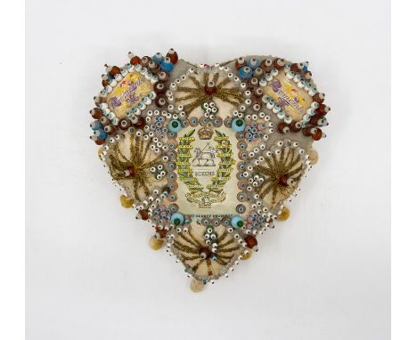 A WWI West Surrey Regiment soldier's sweetheart pin cushion, extensive beadwork and tassel trimmed, height 16cm