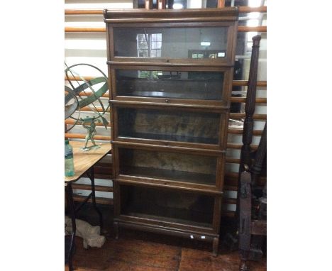 An Early 20th Century Oak stackable five tier Globe Wernicke Bookcase fitted raising glass inlaid doors on each shelf.