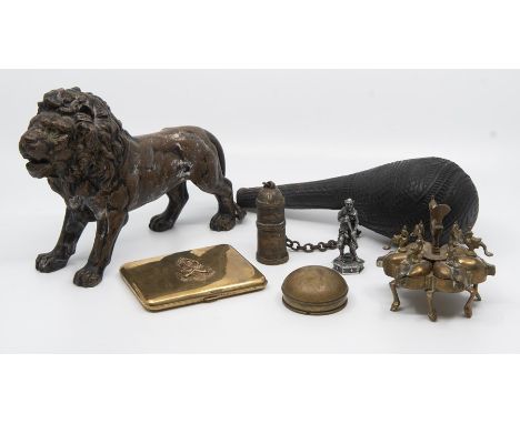 A cast metal Lion, carved powder flask, brass cigarette case, a miniature sun dial in domed case, etc