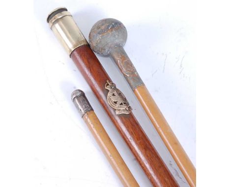 A WW II swagger stick, having an applied Canada Royal Montreal Regiment crest, the brass bullet tip numbered 42, 64cm, togeth