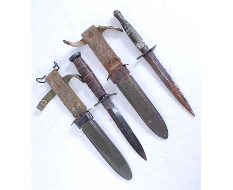 A US Army M3 trench knife, the 16.5cm steel blade stamped U.S. M3, further stamped to the crossguard, having a grooved leathe