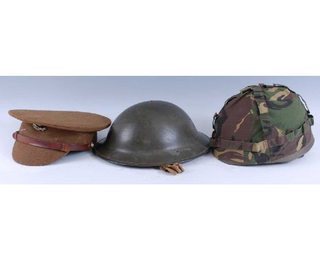 An Officer's dress cap with 9th Lancers badge, together with a Brodie helmet, a plastic helmet marked TCK888C with camouflage