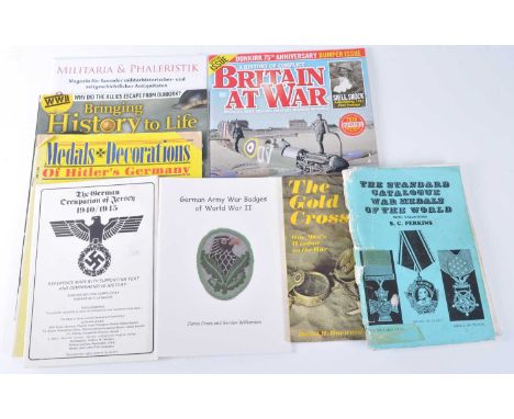 A collection of military related literature to include German Army Badges of World War II, The Gold Cross One Man's Window on