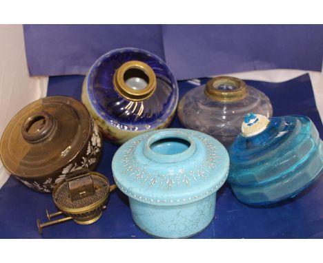 A collection of vintage oil lamp glass reservoirs 