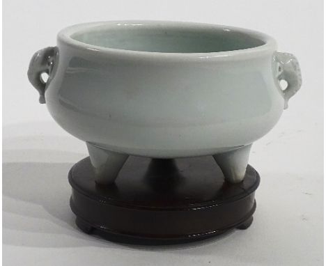 A Chinese blanc de chine pottery censor, of squat form with elephant trunk handles, raised on three small feet on a circular 