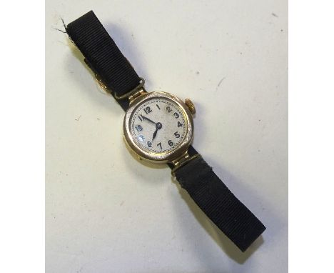 A 9ct gold Swiss wristwatch by Hatis Standard, the white enamel face with Arabic numerals, on black material strap, stamped 3