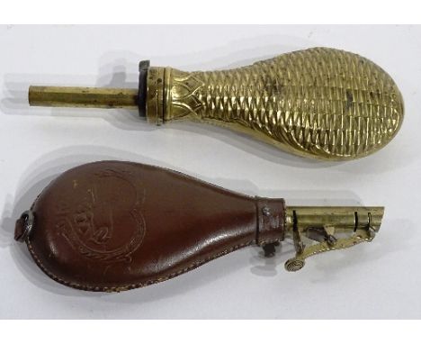 An antique brass powder flask, 23cm long, together with an antique leather mounted shot flask (2)