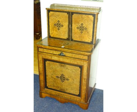 A Victorian burr walnut and ebonised inlaid writing cabinet, with gilt metal gallery above two panelled doors enclosing stati