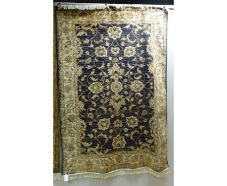 A Machine made Ziegler carpet, the allover gold foliate motifs over navy ground with cream and gold floral border, 230 x 160c