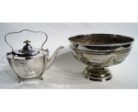 A plated punch bowl, of circular design with floral swag decoration and inscription dated 1911 to front, 17cm high x 26cm dia