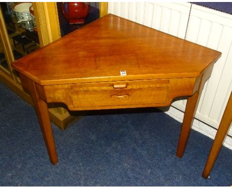 A retro walnut corner writing table, with pull out slide above drawers, raised on tapered supports, 65cm high x 91cm wide x 5