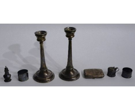 A mixed lot of silver, to include a pair of silver candlesticks, hallmarks faded, together with two silver condiments, two si