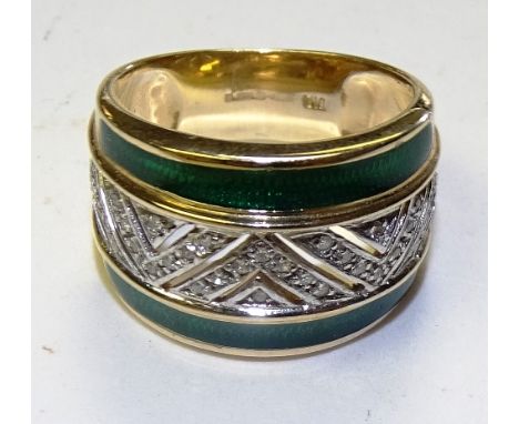 A 9ct gold diamond and green enamel ring, the small brilliant cut diamonds in central pierced zig-zag formation flanked by st