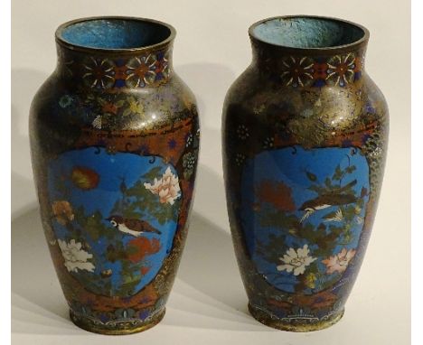 A pair of Chinese style cloisonne vases, decorated with panels of birds in foliage on blue enamel ground within multicoloured