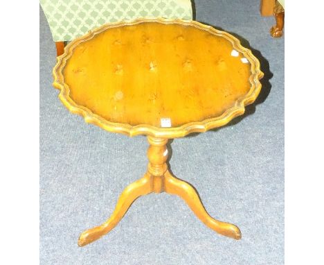 A snap action bird cage table, the circular tilt top with pie crust edging, raised on turned column and tripod supports, 64cm