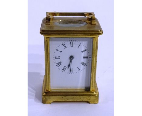 A brass carriage clock, the white enamel dial with Roman numerals and minute track, with key, 10cm high