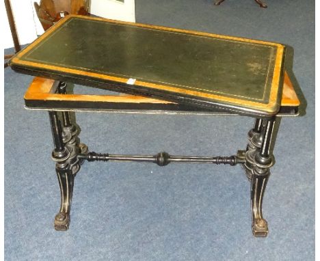 A Victorian aesthetic style ebonised and walnut card table, lacking swivel mechanism raised on turned columns and scroll supp