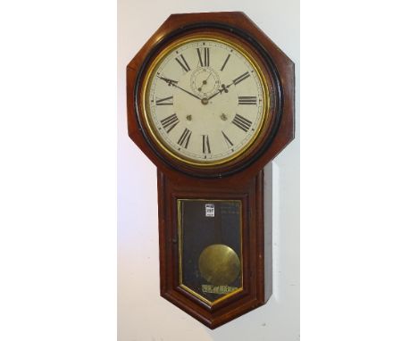 A late Victorian mahogany American drop dial wall clock, the octagonal hood enclosing white enamel dial with Roman numerals a