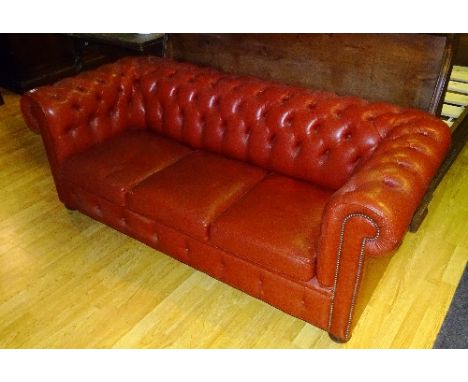 A red Chesterfield two seater sofa, 66cm high x 185cm wide