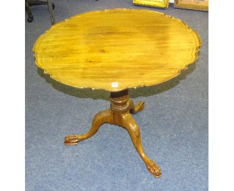 A George III mahogany bird cage supper table, the circular snap action top with pie crust edging, raised on tapered fluted co