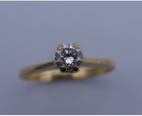 An 18 ct gold diamond solitaire ring. Ring size G/H. 1.8 grammes total weight.