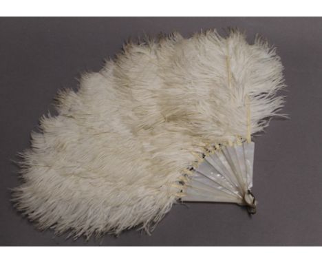 A vintage ostrich feather and mother-of-pearl fan. 38 cm long.
