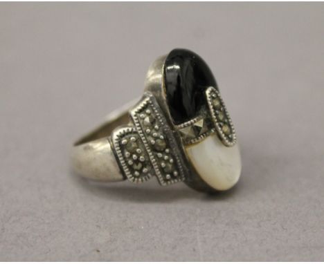 A mother-of-pearl, black jet and marcasite ring.  Ring size L.