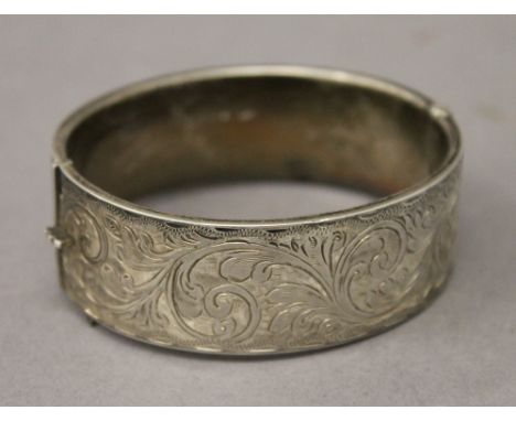 A silver hallmarked engraved bangle. 6.5 cm wide. 29 grammes.