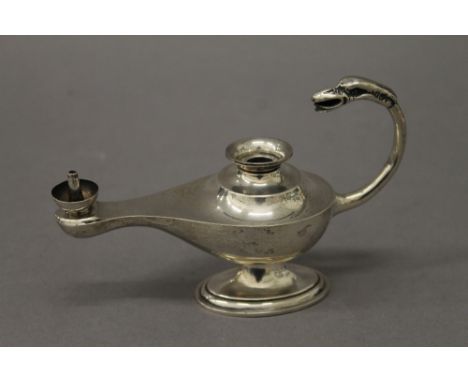 A silver table lighter formed as an oil lamp. 14 cm long. 106.8 grammes total weight.