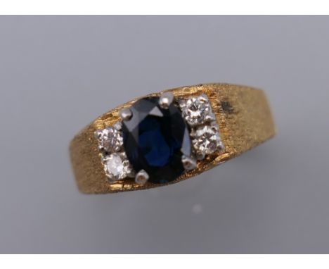 An unmarked gold diamond and sapphire ring. Ring size N/O. 5.5 grammes total weight.