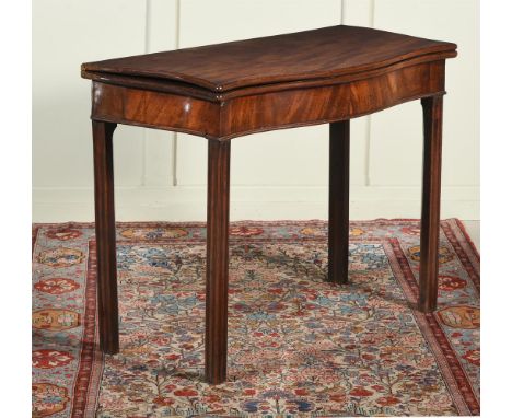 A GEORGE III MAHOGANY FOLDING CARD TABLE  CIRCA 1780 Of serpentine outline, the hinged top enclosing a leather playing surfac