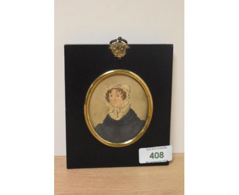 19th Century School, a portrait miniature of a lady wearing a bonnet, set within an ebonised frame, with gilt mount, and Scot