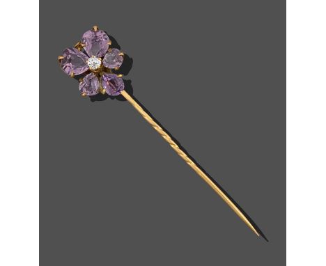 A Flower Head Amethyst and Diamond Stick Pin, the stylised flower head formed of an old cut diamond within a border of five v