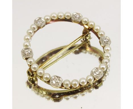 An American Belle Epoque gold, diamond and seed pearl brooch, circa 1910, 14 carat gold ring of 24 pearls separated by six di