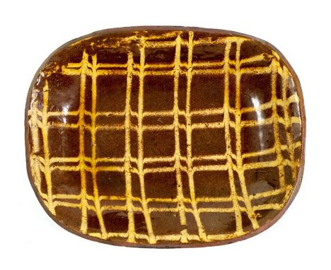 An 18th century Staffordshire slipware loaf dish, shallow rectangular form, slip decorated with lattice cheque design, 32.5cm