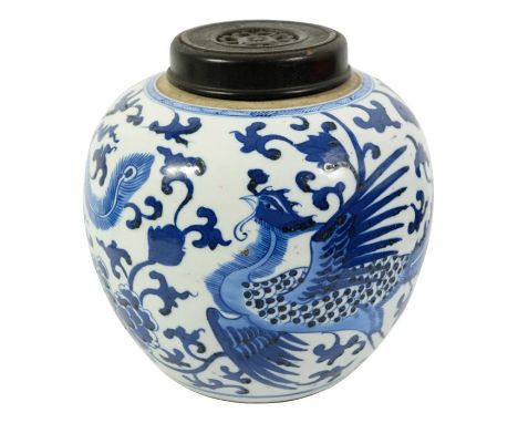 A Chinese blue and white ginger jar, possibly Kangxi or later, painted with phoenix and foliate scroll design, with wooden li