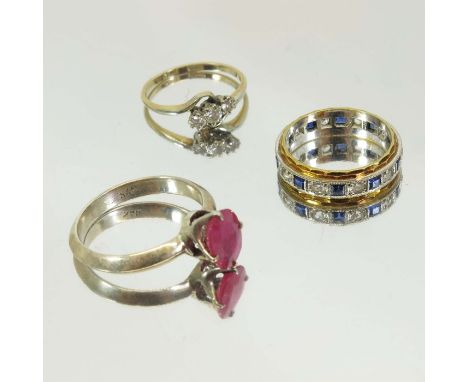 A three stone diamond ring, together with a sapphire and diamond eternity ring and a silver and synthetic ruby ring (3)