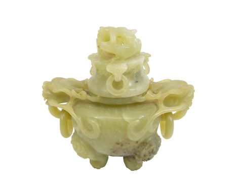 A Chinese carved jade type censer, reticulated and relief moulded lions mask and ring handles, the lid with a dragons head an