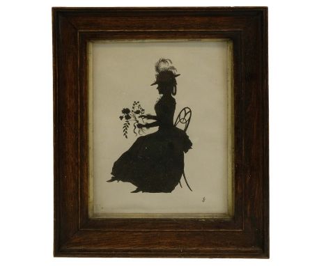 A 19th century silhouette portrait of a woman holding flowers, signed with monogram, 19cm x 15cm, framed