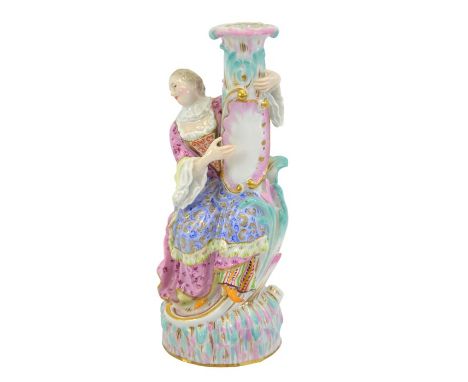 A Meissen figural candlestick, after J J Kandler, circa 1860, modelled as Columbine from Commedia dell'Arte, incised numbers 
