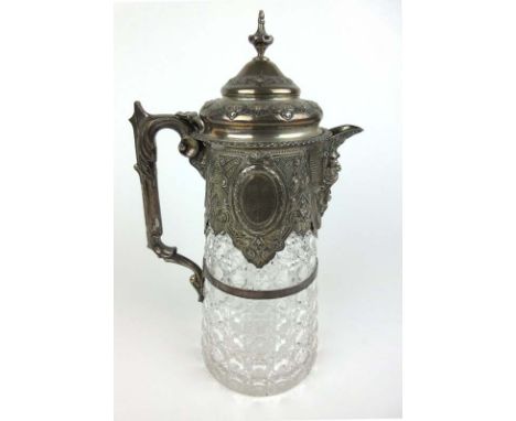 A Victorian silver mounted glass claret jug with vacant cartouche amidst engraved and embossed decoration, hobnail cut glass 