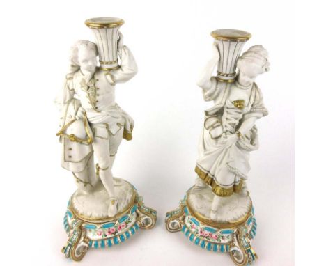 A pair of Worcester-type parian ware and gilt highlighted figural candlesticks modelled as a gentleman and his wife, with det
