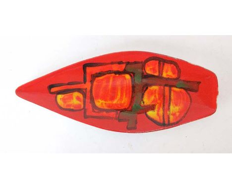 A Poole pottery dish of spearhead form decorated in the 'Delphis' pattern with geometric shapes on a red ground, shape 82, l.