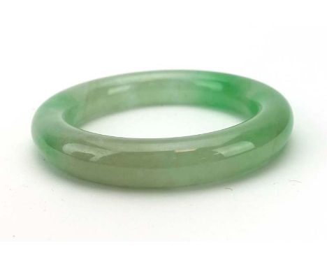 A pale green jade bangle, internal d. 5.7 cm